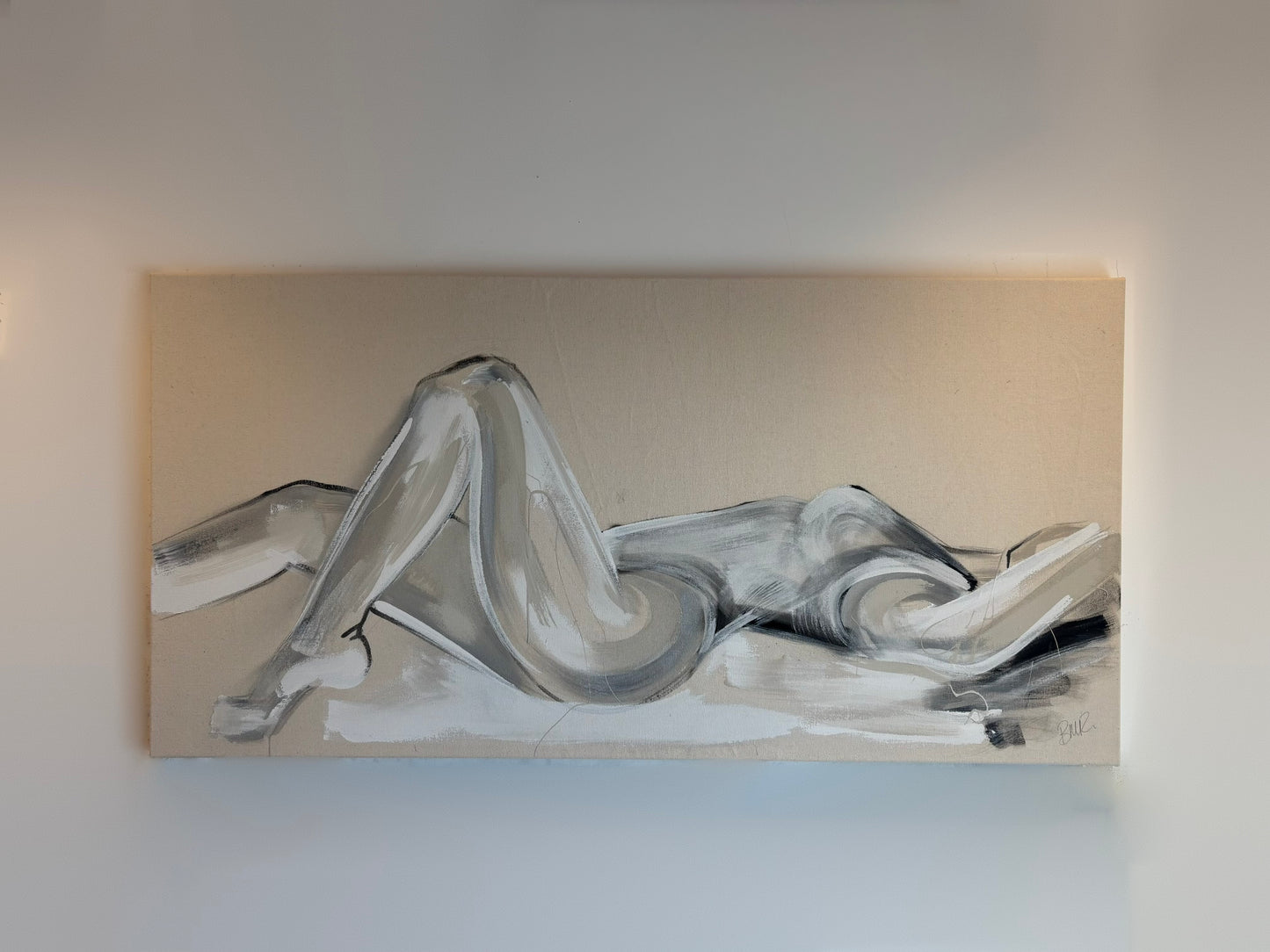 Figure painting of a lady lying across the canvas in white, grey and black tones. Painted by Artist Briony May Richardson at StudioBMR