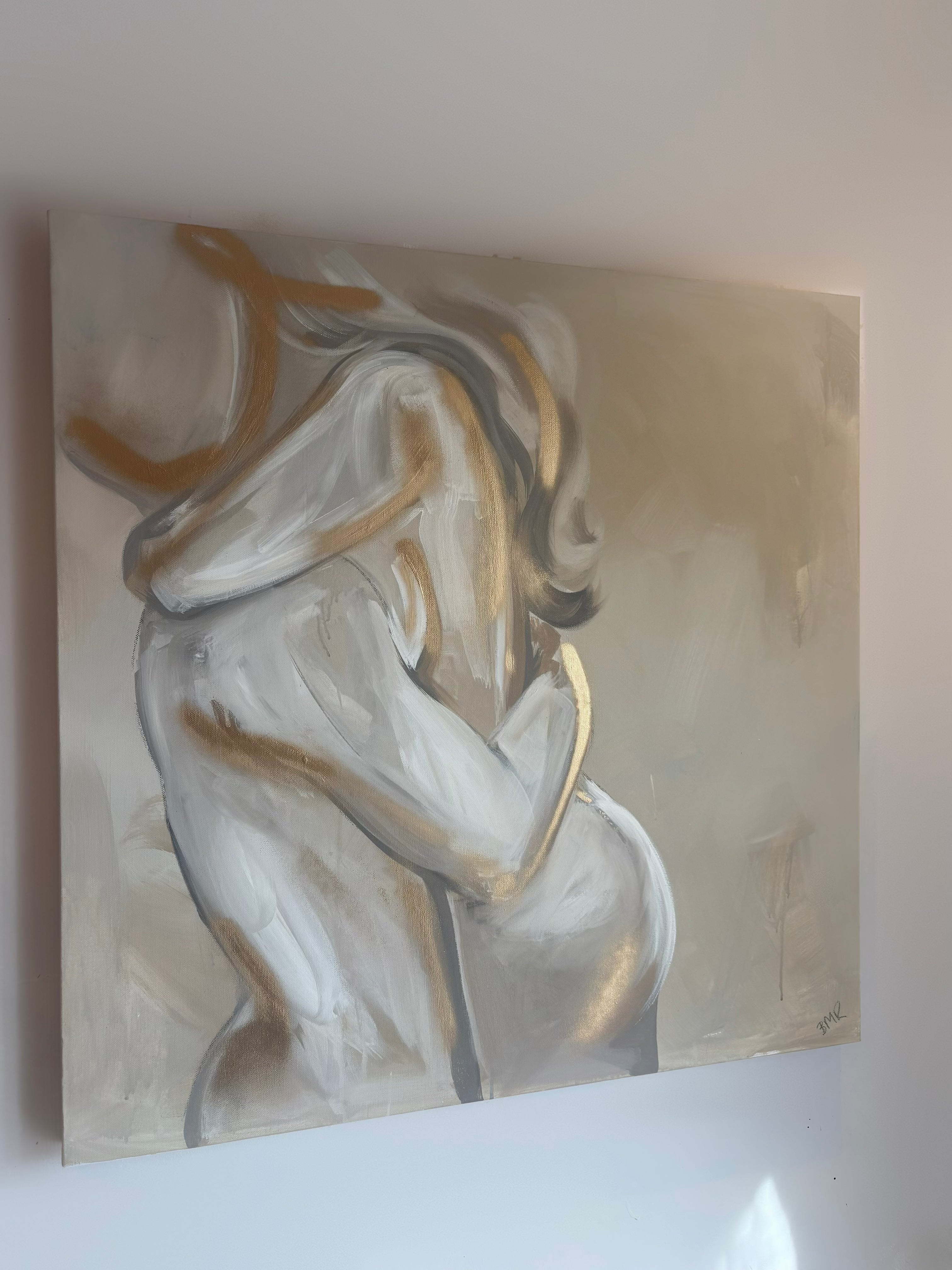 UK artist Briony May Richardson has hand painted this soft and romantic neutral beige, white and grey toned painting of a man and woman hugging. The painting features gold elements and is quite abstract in style.